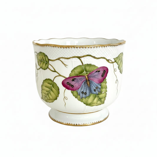 Hand painted decorative vase by Anna Weatherley with butterfly and leaf design on a white background