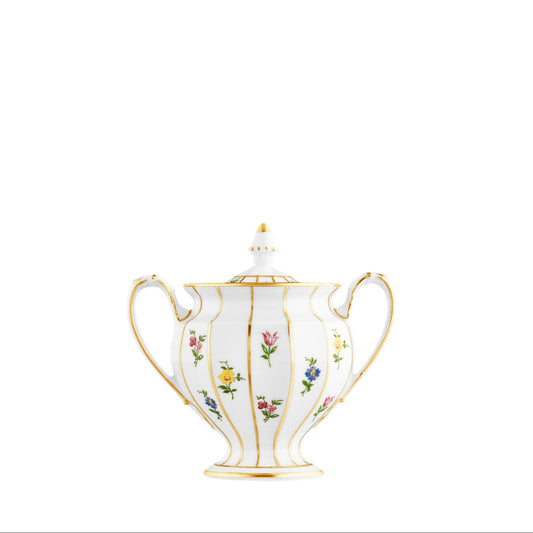A white porcelain covered sugar bowl with floral patterns and gold accents.